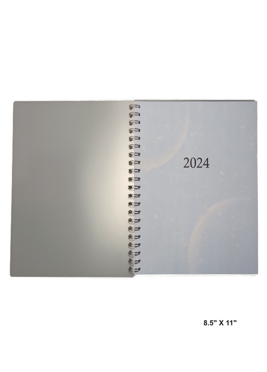 Image of a hand-made 8.5" x 11" 12-month planner with moons on each corner. Great for planning and organization.