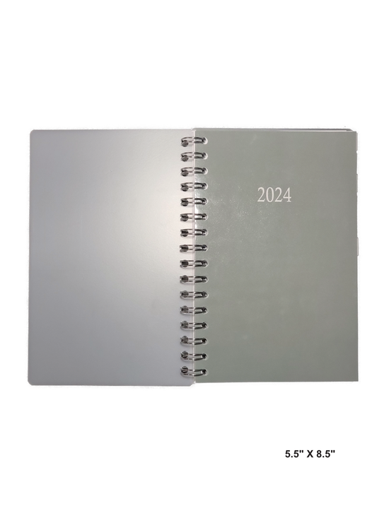 Image of a hand-made 5.5" x 8.5" 12 month planner with solid sage green cover. Great for planning and organization. 