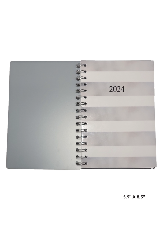 Image of a hand-made 5.5" x 8.5" 12-month planner with silver and white stripes. Great for planning and organization.