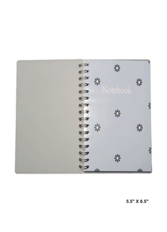 Image of hand-made 5.5" x 8.5" notebook with blue flowers with a light blue background. The notebook's pages are lined for writing or journaling